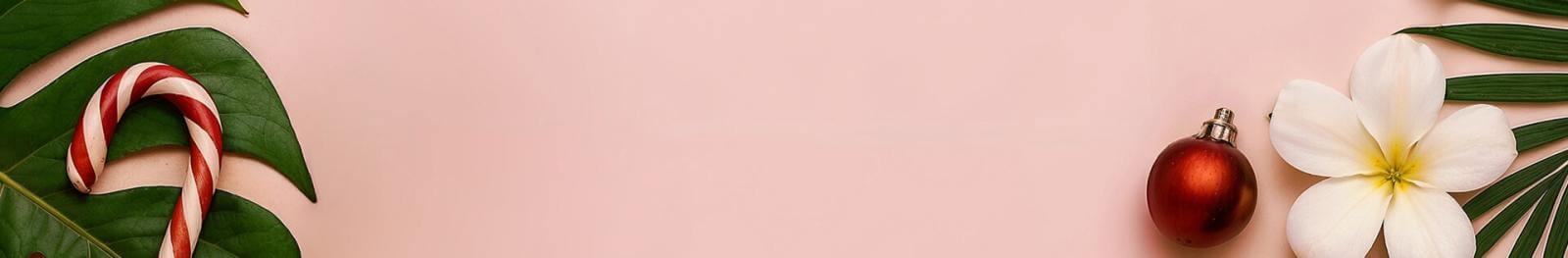 Pink background with green leaf, flower, and Christmas decorations.