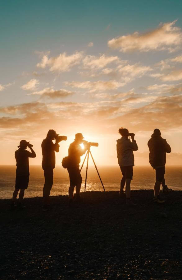 Birdwatcher silhouettes with binoculars in the Canary Islands.